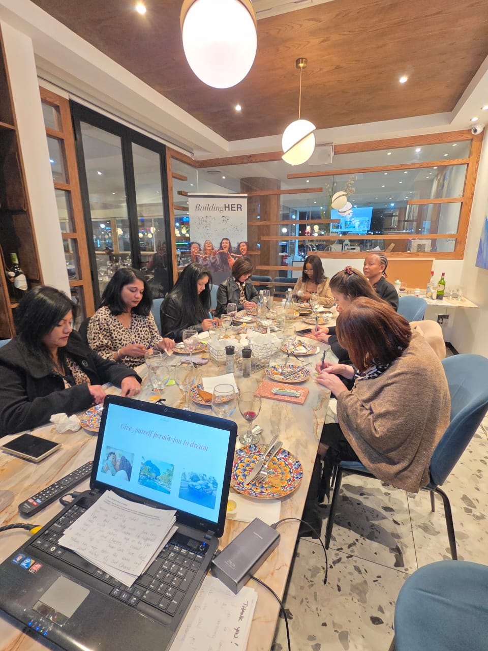 BuildingHer session with women taking notes